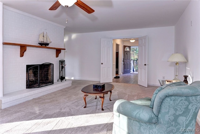 living room featuring light carpet, a fireplace, and ceiling fan