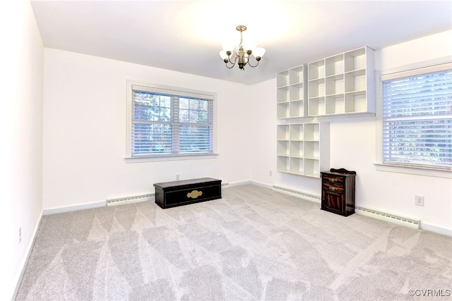 unfurnished living room featuring plenty of natural light, a chandelier, and baseboard heating