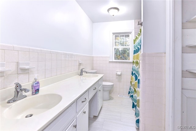 bathroom featuring tile patterned floors, toilet, a shower with curtain, tile walls, and vanity