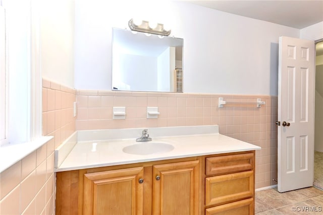 bathroom featuring vanity, tile patterned flooring, and tile walls