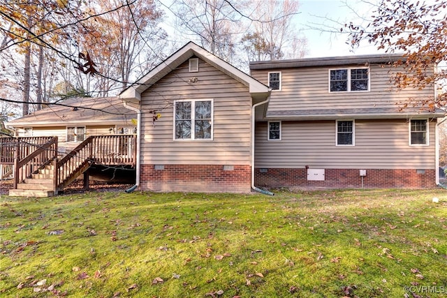 rear view of house with a deck and a lawn