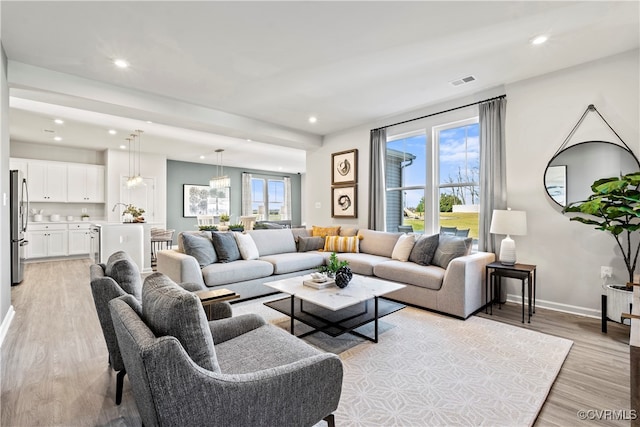 living room with light hardwood / wood-style floors and a wealth of natural light