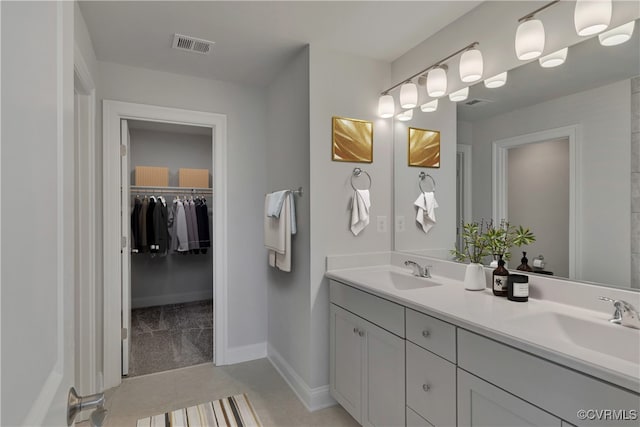 bathroom with tile patterned floors and vanity