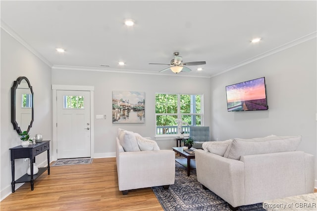 living room featuring ceiling fan, light wood-type flooring, and ornamental molding