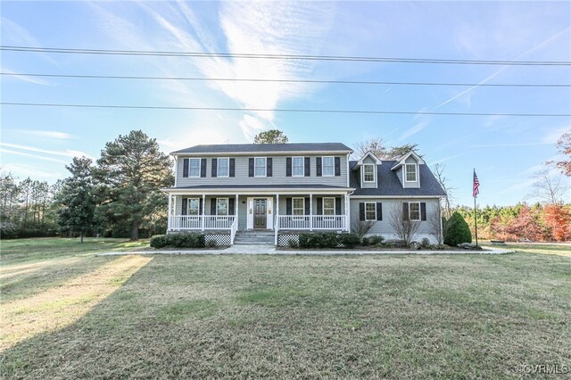 colonial inspired home featuring a front lawn and covered porch