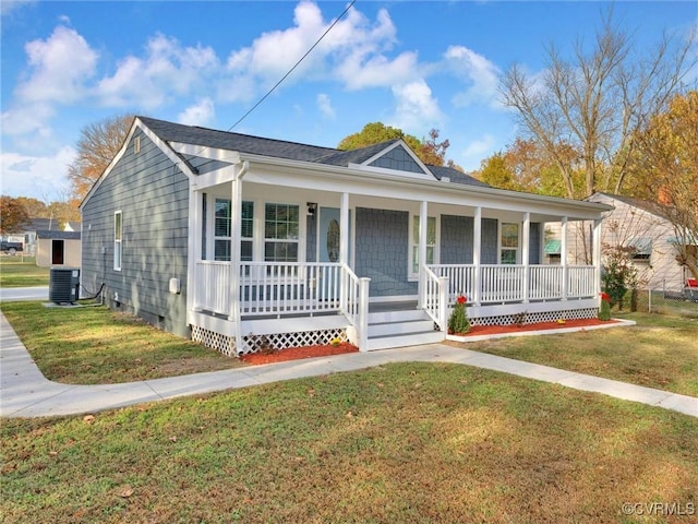 view of front of home featuring central AC, a front lawn, and a porch