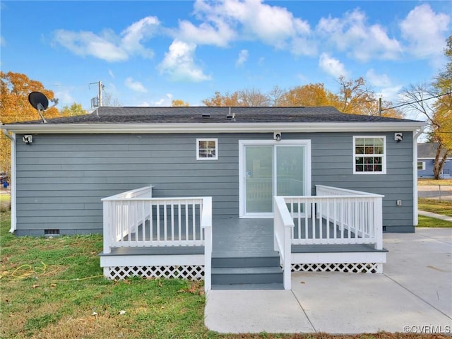 rear view of property featuring a patio and a deck