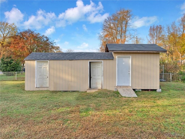 view of outbuilding with a yard