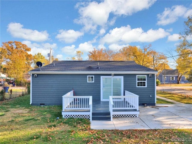 rear view of property featuring a yard, a patio area, and a deck