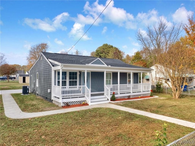 view of front of property with central AC, a front yard, and covered porch