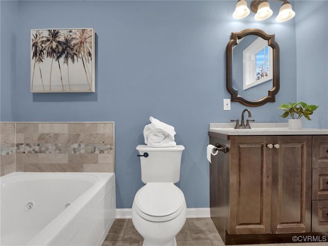 bathroom with vanity, toilet, tile patterned flooring, and a tub