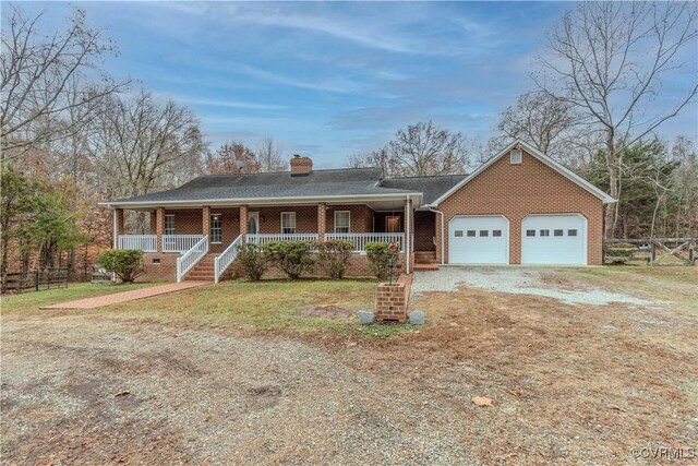 single story home featuring a porch and a garage