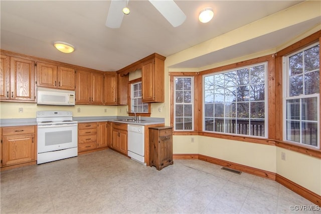 kitchen featuring white appliances, ceiling fan, and sink