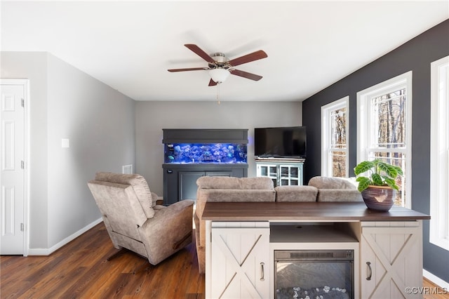 living room with wine cooler, ceiling fan, and dark wood-type flooring