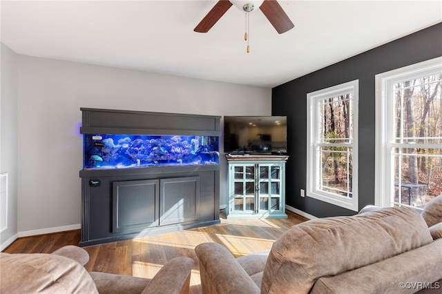 living room featuring hardwood / wood-style floors and ceiling fan