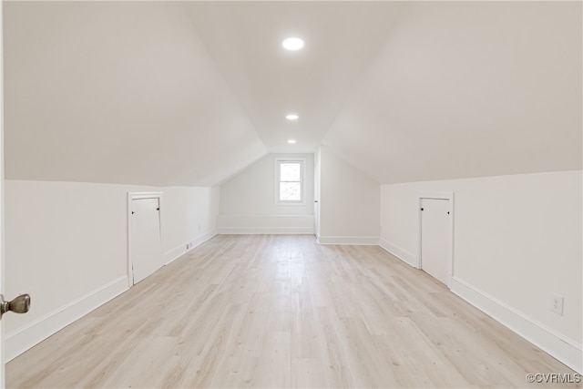 bonus room featuring vaulted ceiling and light wood-type flooring