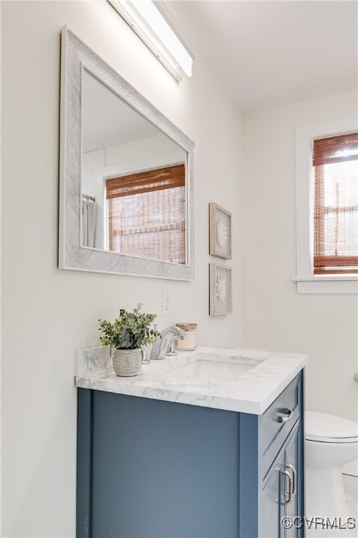 bathroom with vanity and toilet