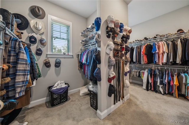 walk in closet featuring light carpet