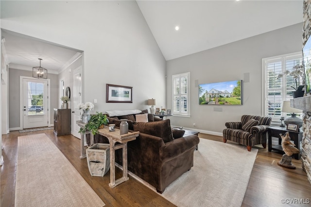 living room featuring dark hardwood / wood-style floors, high vaulted ceiling, and plenty of natural light