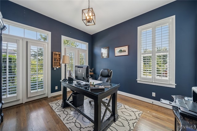 office featuring french doors, wood-type flooring, and an inviting chandelier