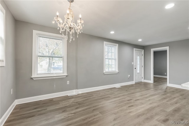 interior space featuring wood-type flooring and a notable chandelier