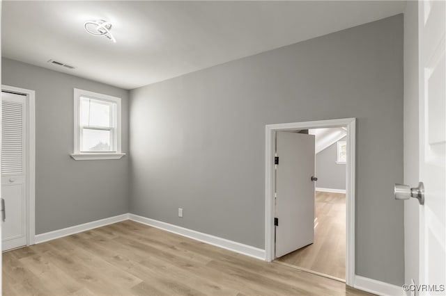 unfurnished bedroom with a closet and light hardwood / wood-style flooring