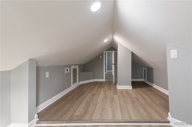 bonus room featuring light hardwood / wood-style floors and lofted ceiling