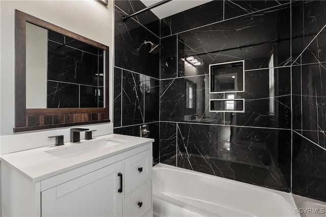 bathroom with vanity and tiled shower / bath