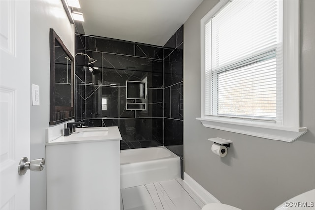 full bathroom featuring vanity, toilet, and tiled shower / bath