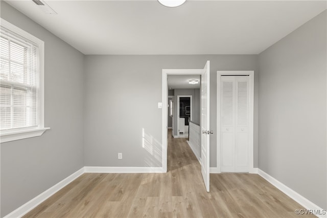 unfurnished room featuring plenty of natural light and light wood-type flooring