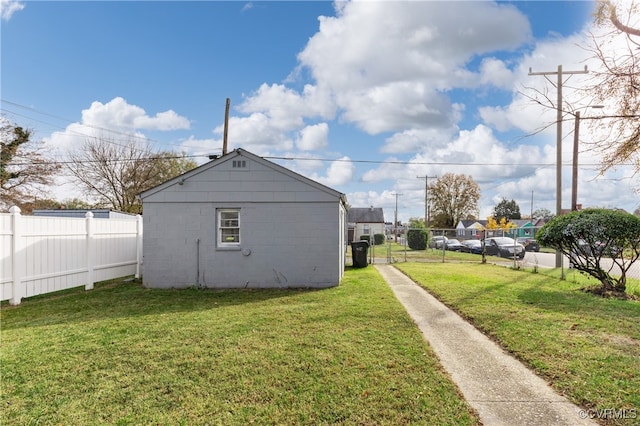 view of side of home with a yard