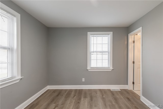 unfurnished room with light wood-type flooring