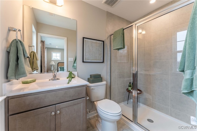 bathroom featuring toilet, an enclosed shower, and vanity