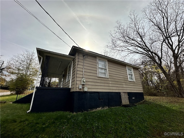 view of side of home featuring a yard