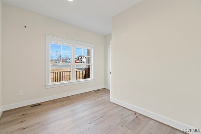 unfurnished room with light wood-type flooring