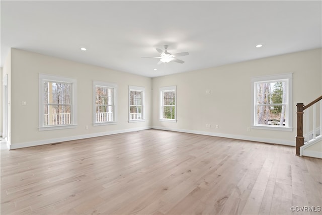 unfurnished living room with ceiling fan and light wood-type flooring