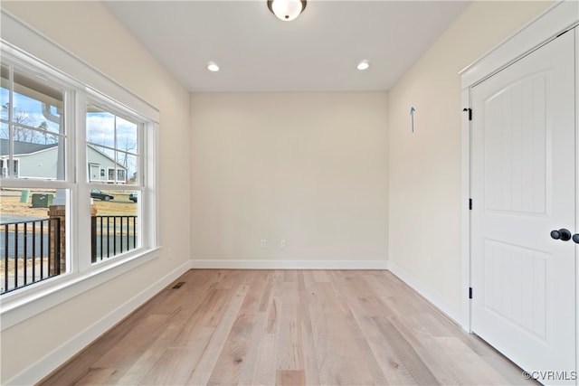 unfurnished room with light hardwood / wood-style floors