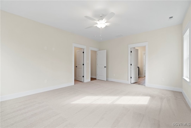 unfurnished bedroom featuring ceiling fan and light colored carpet