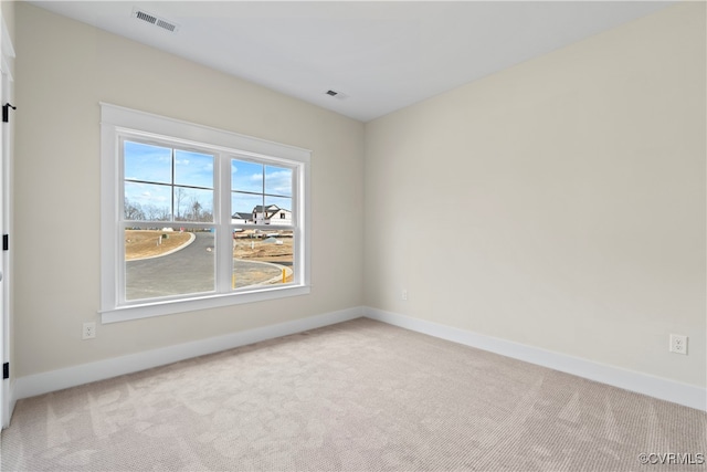 empty room featuring light carpet