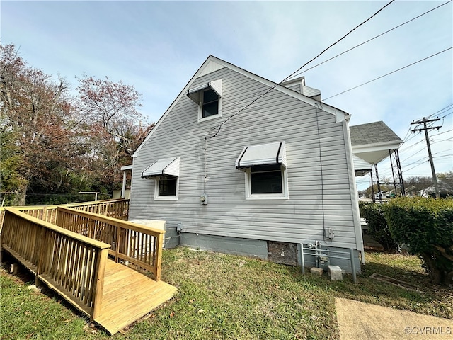 rear view of house with a lawn and a deck