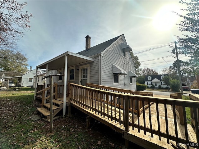 rear view of house featuring a wooden deck