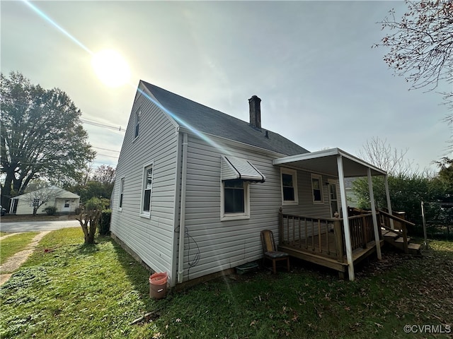 back of property featuring a lawn