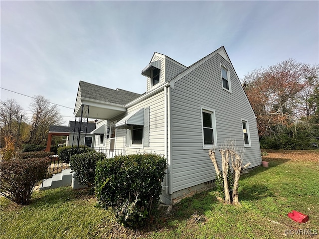 view of side of home with a yard