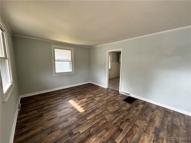 empty room with crown molding and dark wood-type flooring