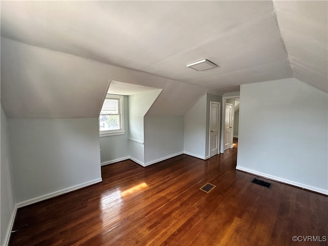 bonus room featuring lofted ceiling and dark hardwood / wood-style floors