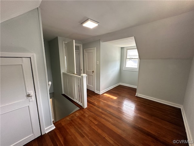 bonus room featuring dark hardwood / wood-style flooring and vaulted ceiling