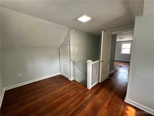 bonus room with lofted ceiling and dark hardwood / wood-style floors