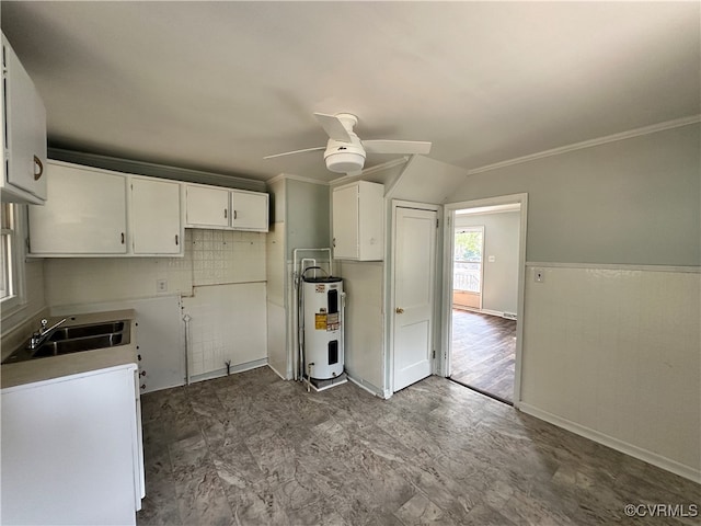 kitchen featuring ornamental molding, ceiling fan, sink, water heater, and white cabinets