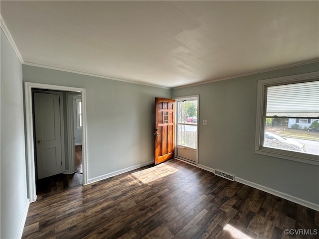 empty room with crown molding and dark wood-type flooring