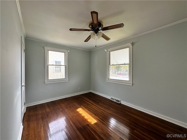 unfurnished room featuring dark hardwood / wood-style floors, a wealth of natural light, and ornamental molding